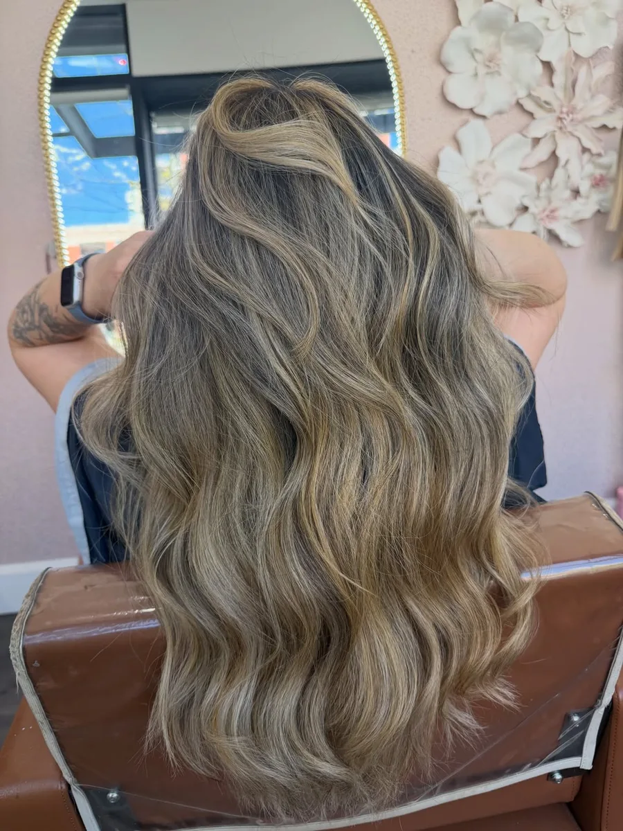 Golden balayage with softly blended highlights and dimensional waves